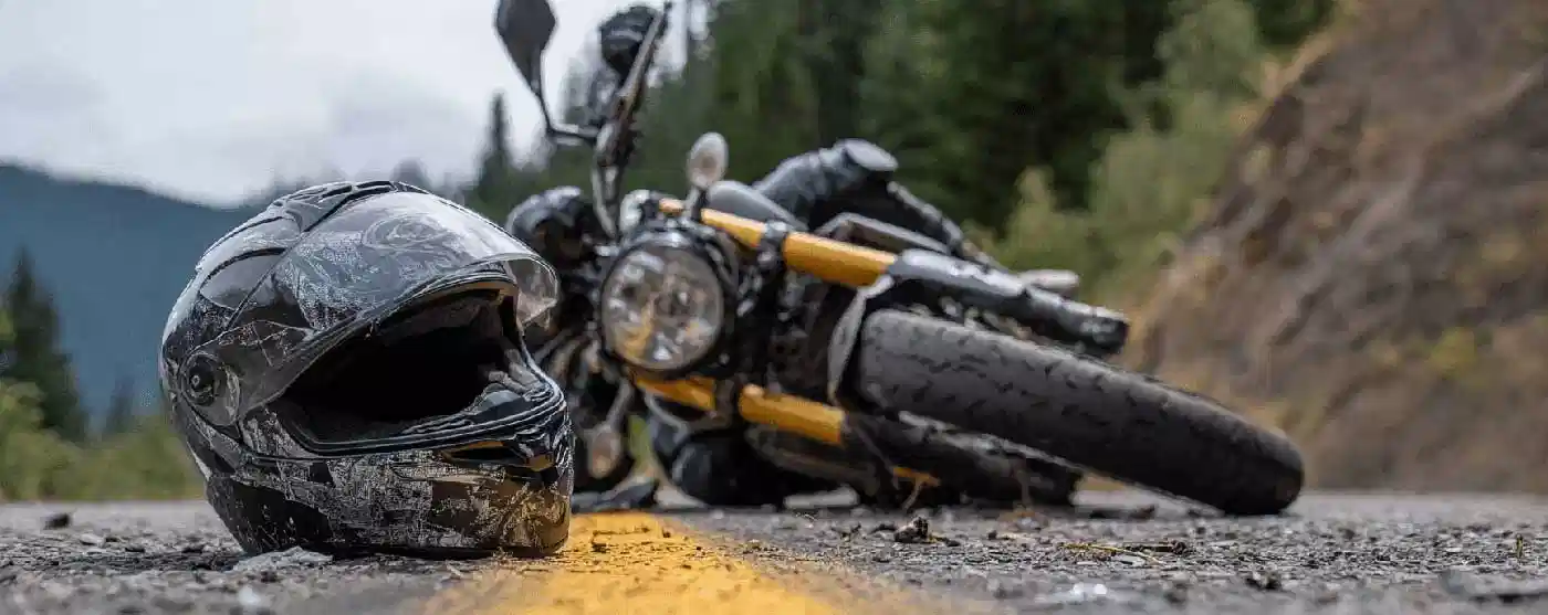A bike lying flat on a road after a motorcycle accident