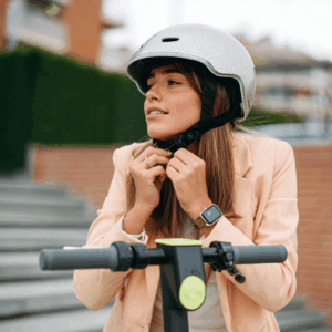 girl strapping helmet before starting her E-scooter journey