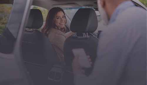 A man entering a rideshare cab