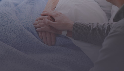Comforting a patient in a hospital bed.